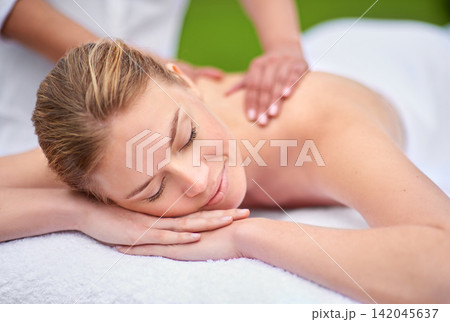 Massage, woman and spa for health, wellness and relaxation in muscles, back and neck for self care. Female person, physical therapy and detox for body with smile, calm and happiness on holiday Massage, woman and spa for health, wellness and relaxation in muscles, back and neck for self care. Female person, physical therapy and detox for body with smile, calm and happiness on holiday 142045637