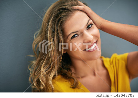 Portrait, smile and woman in studio for happiness, positive attitude or feel good mood on gray background. Face, confidence and person for relax, cheerful and chilling on weekend with dark backdrop 142045708