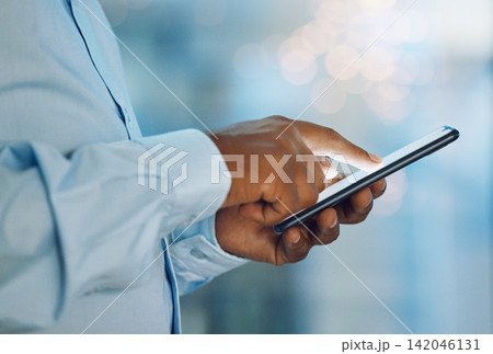 Black man, hands and browsing with phone for news, social media or online research at office. Closeup of African, male person or employee on mobile smartphone for chatting, texting or scrolling app Black man, hands and browsing with phone for news, social media or online research at office. Closeup of African, male person or employee on mobile smartphone for chatting, texting or scrolling app 142046131