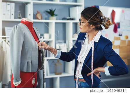Tailor, fashion and mannequin in boutique workshop with creative seamstress planning project. Luxury, designer and woman fitting fabric for clothes in retail, small business or sewing in warehouse 142046814