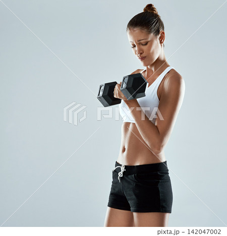 Challenge, dumbbell and weightlifting with woman, fitness in studio and muscle training isolated on grey background. Exercise, strong athlete and heavy equipment for workout with body and power Challenge, dumbbell and weightlifting with woman, fitness in studio and muscle training isolated on grey background. Exercise, strong athlete and heavy equipment for workout with body and power 142047002