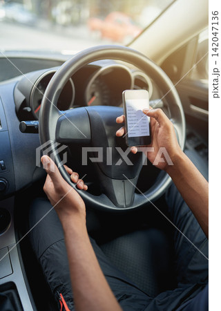 Phone, texting and driving with hands of driver on steering wheel with scroll, danger and risk. Road safety, awareness and person in car with smartphone, distraction and attention with auto insurance Phone, texting and driving with hands of driver on steering wheel with scroll, danger and risk. Road safety, awareness and person in car with smartphone, distraction and attention with auto insurance 142047136