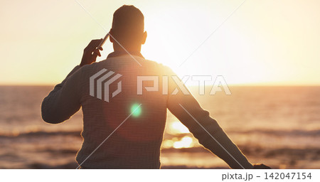 Man, phone call and sunset sky at beach for talk, contact or communication by waves, water and nature. Back view, smartphone and chat by ocean on mobile network in summer sunshine at dusk on vacation Man, phone call and sunset sky at beach for talk, contact or communication by waves, water and nature. Back view, smartphone and chat by ocean on mobile network in summer sunshine at dusk on vacation 142047154
