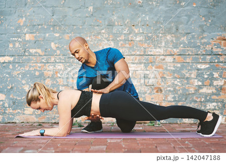 Support, fitness and coach with woman for workout, exercise and on yoga mat for sport. Teamwork, personal trainer and athlete in plank by brick wall at gym for wellness, training or healthy progress Support, fitness and coach with woman for workout, exercise and on yoga mat for sport. Teamwork, personal trainer and athlete in plank by brick wall at gym for wellness, training or healthy progress 142047188