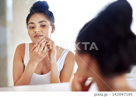 Morning, mirror and woman popping pimple on face with hands, dirt or scar on skin in home. Dermatology, facial wellness and girl in bathroom to squeeze acne, checking reflection or skincare routine Morning, mirror and woman popping pimple on face with hands, dirt or scar on skin in home. Dermatology, facial wellness and girl in bathroom to squeeze acne, checking reflection or skincare routine 142047195