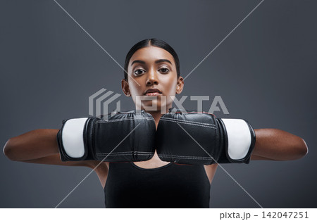 Portrait, girl and boxing gloves in studio, training and sport for exercise, fitness and Indian boxer. Workout, isolated and battle or mma, strong in dark background for fight, power and challenge Portrait, girl and boxing gloves in studio, training and sport for exercise, fitness and Indian boxer. Workout, isolated and battle or mma, strong in dark background for fight, power and challenge 142047251