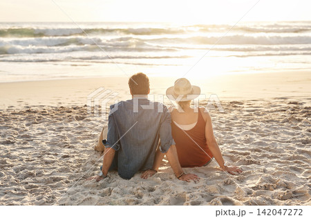Couple, vacation or beach trip sitting on blanket for picnic or relaxing on seashore getaway. Love, man and woman together happy in nature by ocean for romantic date, sunset or holiday in California Couple, vacation or beach trip sitting on blanket for picnic or relaxing on seashore getaway. Love, man and woman together happy in nature by ocean for romantic date, sunset or holiday in California 142047272