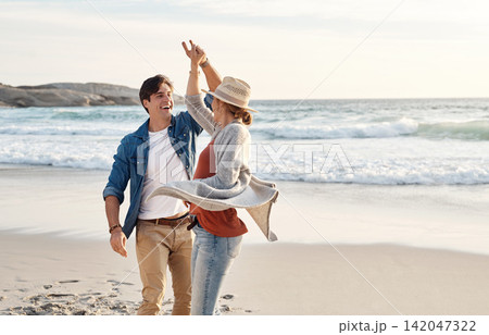 Couple, dancing and happy together on beach, seaside and holiday for relationship bonding and love or affection. Ocean, calm and fun with partners on vacation trip, relax and movement for joy on date Couple, dancing and happy together on beach, seaside and holiday for relationship bonding and love or affection. Ocean, calm and fun with partners on vacation trip, relax and movement for joy on date 142047322