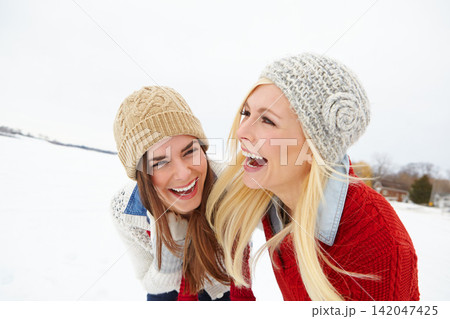 Snow, travel and girl friends laughing outdoor in winter on romantic vacation, adventure or holiday. Happy, smile and young women bonding together in cold weather on weekend trip in Iceland. Snow, travel and girl friends laughing outdoor in winter on romantic vacation, adventure or holiday. Happy, smile and young women bonding together in cold weather on weekend trip in Iceland. 142047425