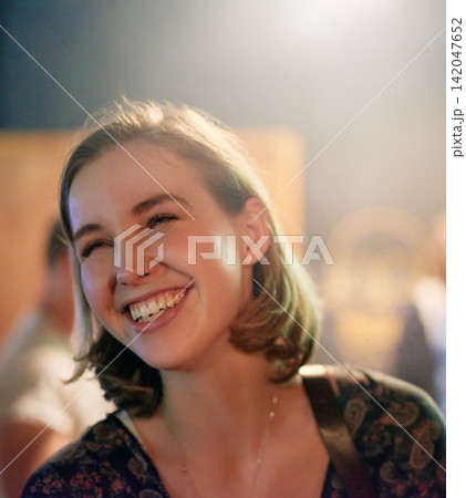 Woman, laugh and happy in restaurant for travel, concert and fun in city. Female person, smile and night out in urban town for party, dinner and celebration in club for enjoyment or socializing 142047652