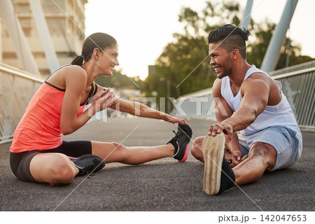 Smile, exercise and couple stretch on bridge for health, wellness or warmup for run. Man, woman and training on road for cardio, preparation and fitness together in city for marathon, jog or sprint Smile, exercise and couple stretch on bridge for health, wellness or warmup for run. Man, woman and training on road for cardio, preparation and fitness together in city for marathon, jog or sprint 142047653