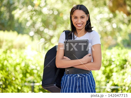 Smile, female student and campus with book in portrait for learning, education and knowledge for goal growth. Woman, school and study at university with information or notes for future development Smile, female student and campus with book in portrait for learning, education and knowledge for goal growth. Woman, school and study at university with information or notes for future development 142047715