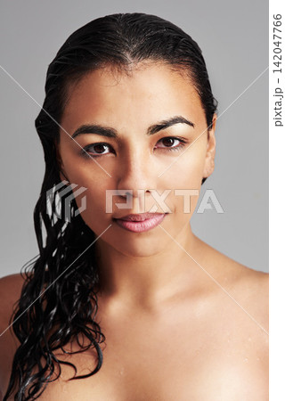 Woman, portrait and beauty with makeup cosmetics, skincare or haircare on a gray studio background. Face of young female person or model with wet hair for hygiene, facial treatment or dermatology Woman, portrait and beauty with makeup cosmetics, skincare or haircare on a gray studio background. Face of young female person or model with wet hair for hygiene, facial treatment or dermatology 142047766