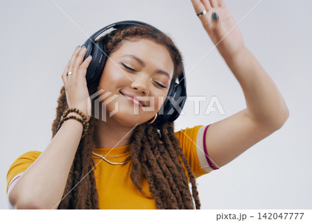 Woman, studio or dance with headphones in closeup for music, streaming or listening with happiness. Female student or celebrate on backdrop with audio for podcast, happy with sound wave in California Woman, studio or dance with headphones in closeup for music, streaming or listening with happiness. Female student or celebrate on backdrop with audio for podcast, happy with sound wave in California 142047777