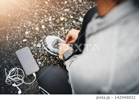 Person, smartphone and shoelace with running or exercise for fitness, health and wellbeing in outdoor. Above, sneakers and committed on workout or jog in morning for training, wellness and self care Person, smartphone and shoelace with running or exercise for fitness, health and wellbeing in outdoor. Above, sneakers and committed on workout or jog in morning for training, wellness and self care 142048032