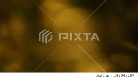 Defocused visual flare. Light leak. Yellow warm blue green colorful rainbow glisten texture optical refraction on abstract bokeh background. 142048184