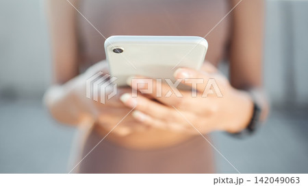 Outdoor, exercise and woman with cellphone, hands and social media with digital app, check progress and wellness. Blue sky, person or runner with smartphone, closeup or typing with fitness or contact 142049063