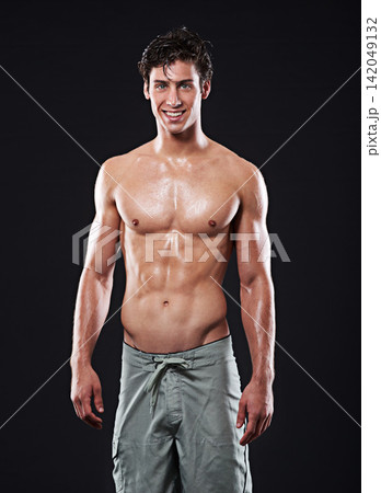 Man, muscular torso and portrait for fitness, exercise or body building for wellness or muscle growth. Male athlete, shirtless and smile in studio and proud with abs and sixpack on dark background Man, muscular torso and portrait for fitness, exercise or body building for wellness or muscle growth. Male athlete, shirtless and smile in studio and proud with abs and sixpack on dark background 142049132