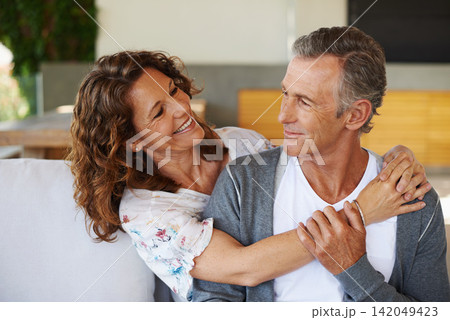 Mature couple, happy and embrace on couch in living room with love, commitment and care. Elderly partners, hug and smile at home with security, compassion and happy together in house or apartment 142049423