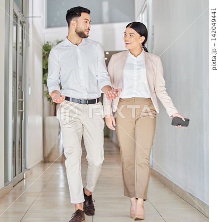 Business people, walking and happy conversation in corridor with gossip, smile and chat in office. Work, friends and woman with man for discussion, talking or news of project, ideas or communication Business people, walking and happy conversation in corridor with gossip, smile and chat in office. Work, friends and woman with man for discussion, talking or news of project, ideas or communication 142049441