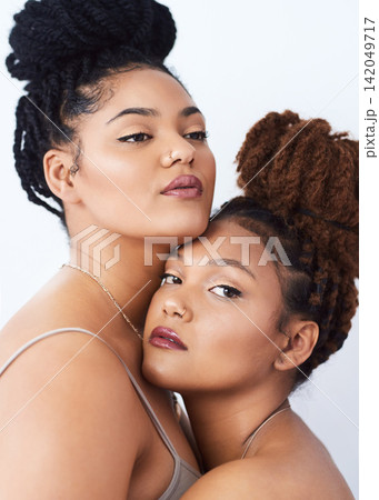 Sisters, portrait and beauty in studio, hug and luxury makeup cosmetics on white background. Women, friends and embrace touch for soft skin, dermatology and skincare bonding or confident for glow Sisters, portrait and beauty in studio, hug and luxury makeup cosmetics on white background. Women, friends and embrace touch for soft skin, dermatology and skincare bonding or confident for glow 142049717
