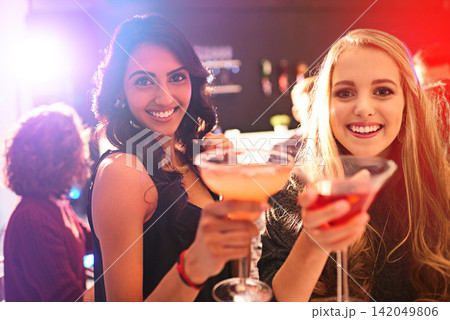 Girl, friends and cocktail with portrait with toast in nightclub, congratulations and happy hour. Women, club and drink with margarita, alcohol and smile at event in new year with cheers in night Girl, friends and cocktail with portrait with toast in nightclub, congratulations and happy hour. Women, club and drink with margarita, alcohol and smile at event in new year with cheers in night 142049806
