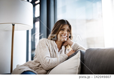 Woman, home and smile in sofa to relax on day off and leisure. Female person, holiday and happy in living room with thinking or rest on break, chill and self care in couch, lounge and satisfied Woman, home and smile in sofa to relax on day off and leisure. Female person, holiday and happy in living room with thinking or rest on break, chill and self care in couch, lounge and satisfied 142049807