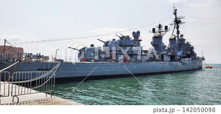A warship moored at the dock. A warship moored at the dock. 142050098