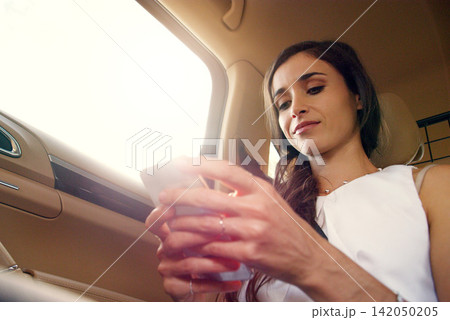Business woman, car and cellphone for social media, video streaming or texting in urban for commute. Journalist or editor in transport with tech for online information, website or internet app Business woman, car and cellphone for social media, video streaming or texting in urban for commute. Journalist or editor in transport with tech for online information, website or internet app 142050205