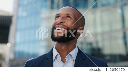 Black business man, face and smile in street for confidence, pride or career by office buildings. African person, corporate employee and outdoor on metro sidewalk for commute, travel or happy in city 142050470