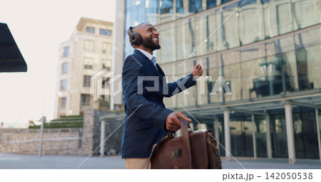 Business man, dancing and headphones in city with smile, steps and spin with bag for commute by office buildings. Person, employee or excited dancer with music, briefcase or outdoor on metro sidewalk Business man, dancing and headphones in city with smile, steps and spin with bag for commute by office buildings. Person, employee or excited dancer with music, briefcase or outdoor on metro sidewalk 142050538
