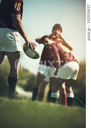 Hand, rugby and team with ball on grass field for training together, competition and cardio workout. Group of athletes, teamwork and sports uniform outdoor for practice game, sunshine and exercise Hand, rugby and team with ball on grass field for training together, competition and cardio workout. Group of athletes, teamwork and sports uniform outdoor for practice game, sunshine and exercise 142050637