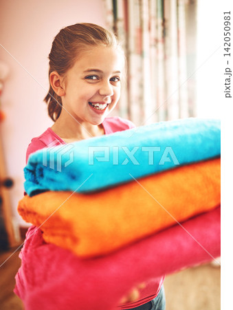 Kid, girl and home or holding laundry with smile, learning and development or cleaning. Child, job or happy with washing in house or living room, help or support with clothes for family or mother Kid, girl and home or holding laundry with smile, learning and development or cleaning. Child, job or happy with washing in house or living room, help or support with clothes for family or mother 142050981