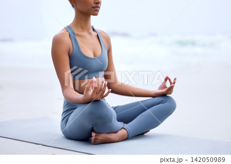 Yoga, lotus meditation and hands at ocean for mindfulness, peace or calm to relax at sea in nature. Zen, beach and woman in padmasana pose for exercise, fitness and wellness for body health outdoor Yoga, lotus meditation and hands at ocean for mindfulness, peace or calm to relax at sea in nature. Zen, beach and woman in padmasana pose for exercise, fitness and wellness for body health outdoor 142050989