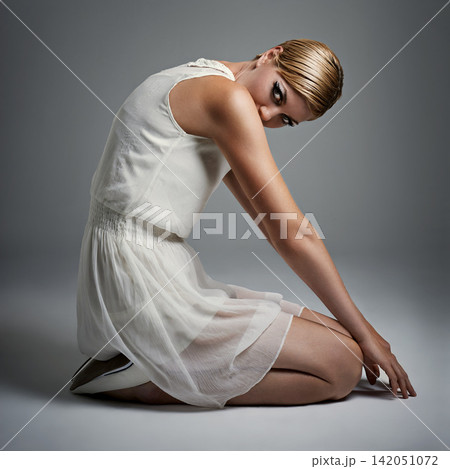 Portrait, woman and ballet in dress at studio on isolated white background, kneeling and makeup for performance. Female person, dancer and performer or artist with practice for concert with fashion Portrait, woman and ballet in dress at studio on isolated white background, kneeling and makeup for performance. Female person, dancer and performer or artist with practice for concert with fashion 142051072
