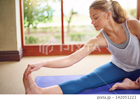 Woman, mat and stretch in house for yoga, fitness and holistic health for exercise recreation and wellness. Female yogi, alone and serious for body relaxation, mindfulness and physical wellbeing 142051221