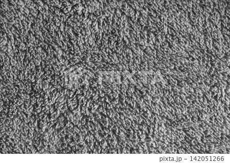 Macro of gray microfiber bath towel, soft fluffy fabric, absorbent material texture background Macro of gray microfiber bath towel, soft fluffy fabric, absorbent material texture background 142051266