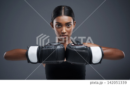 Portrait, gloves and Indian woman with boxer for sports, combat and training for fitness. Self defence, girl or mma fighter for performance, workout and muay thai and cardio or impact exercise Portrait, gloves and Indian woman with boxer for sports, combat and training for fitness. Self defence, girl or mma fighter for performance, workout and muay thai and cardio or impact exercise 142051339
