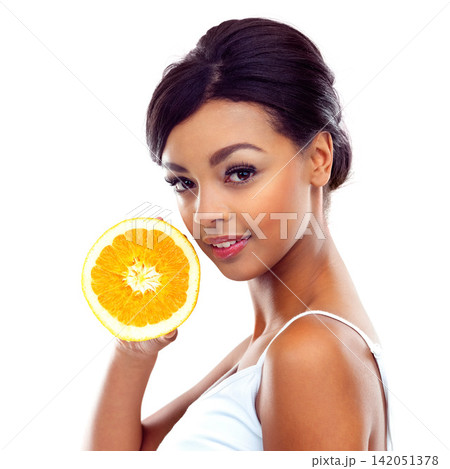 Portrait, diet and woman with orange, nutrition and sustainable eating to lose weight in studio. Citrus fruit, face and girl with fresh food for detox, vitamin c and gut health on white background. 142051378