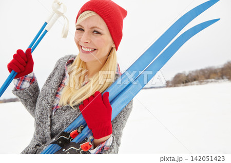 Woman, portrait and happy on vacation with ski equipment for alpine adventure, fun and exploring snowy wilderness. Girl, smile and outdoor on winter holiday in Alaska for getaway and travel tour. 142051423