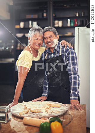 Cooking, smile and portrait of senior couple in kitchen at home with dough, flour and ingredients for meal. Happy, food and elderly man and woman preparing dinner, lunch or supper together at house. 142051618