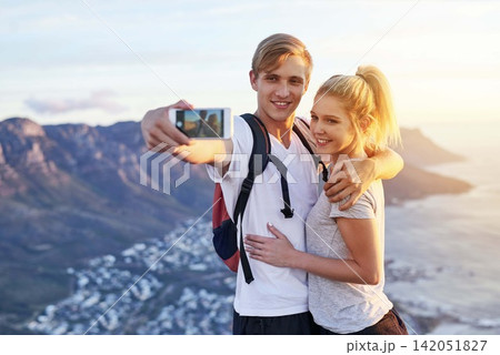 Couple, hiking and selfie on mountain with smile for adventure blog, update or online post together. Man, woman and happy with digital photography in nature for fitness, travel memory or social media Couple, hiking and selfie on mountain with smile for adventure blog, update or online post together. Man, woman and happy with digital photography in nature for fitness, travel memory or social media 142051827