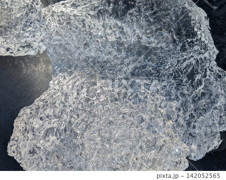 Close-Up Texture of Clear Glacial Ice on Dark Deck Close-Up Texture of Clear Glacial Ice on Dark Deck 142052565