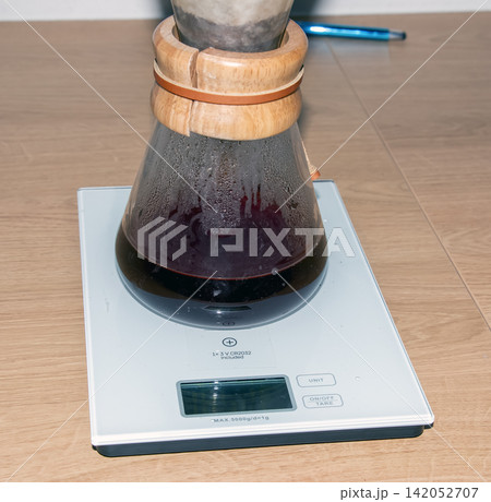 Close View of Dark Brewed Coffee in Glass Pour-Over Carafe Close View of Dark Brewed Coffee in Glass Pour-Over Carafe 142052707