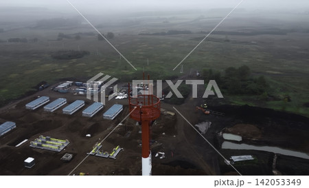 Aerial view of an industrial construction site with central tower Aerial view of an industrial construction site with central tower 142053349