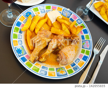 Chicken thigh served with potatoes on dinner plate Chicken thigh served with potatoes on dinner plate 142055835
