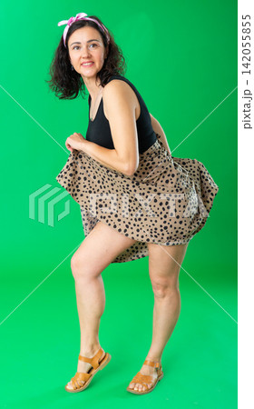Adult woman in dress posing against on green screen. Chroma key compositing Adult woman in dress posing against on green screen. Chroma key compositing 142055855