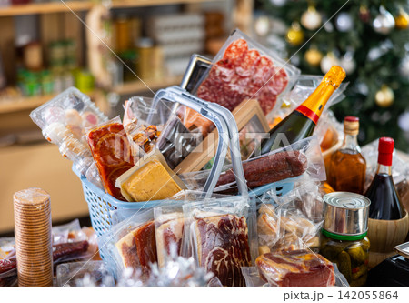Assortment of goods on counter, basket with products on table near scale, New Year Eve Assortment of goods on counter, basket with products on table near scale, New Year Eve 142055864