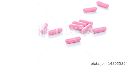 Pink capsule pills on white background. Pharmaceutical industry. Vitamins, minerals, and supplements concept. Pharmacy products. Pharmaceutical medicine. Prescription drugs. Healthcare and medicine. Pink capsule pills on white background. Pharmaceutical industry. Vitamins, minerals, and supplements concept. Pharmacy products. Pharmaceutical medicine. Prescription drugs. Healthcare and medicine. 142055894