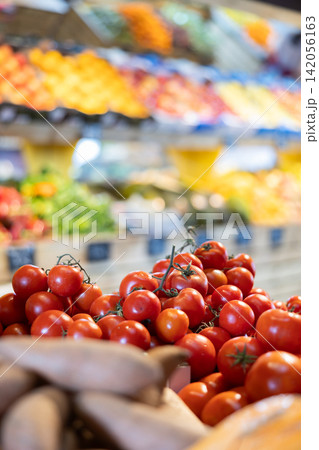 Fresh red tomatoes displayed on store counter for sale Fresh red tomatoes displayed on store counter for sale 142056163